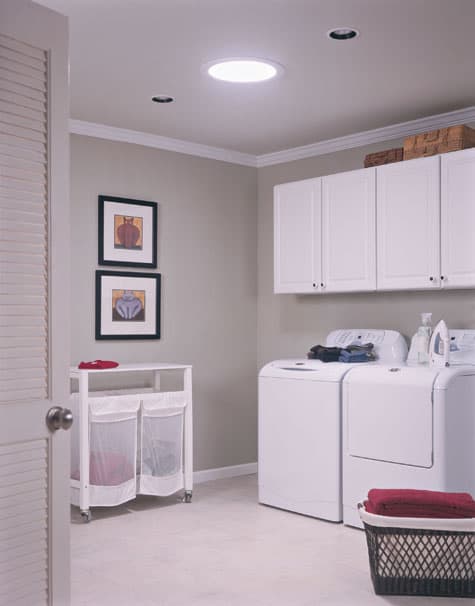 Tubular skylight brightens a windowless laundry room, minimizing the need for electrical lighting.