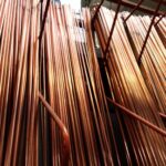 Rigid copper pipes in varying thicknesses arranged vertically.