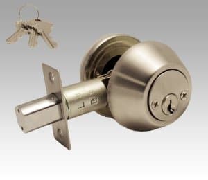 A singled-sided keyed, cylinder deadbolt over a gray background.