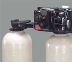 Dual alternating water softeners with two resin tanks and a metered valve.