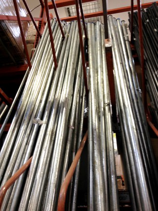 Galvanized steel pipes in varying sizes arranged vertically.