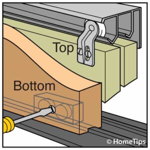 Sliding door's top and bottom rails, including a screwdriver adjusting a roller.