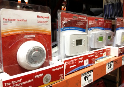 A display full of new mechanical and digital thermostats.