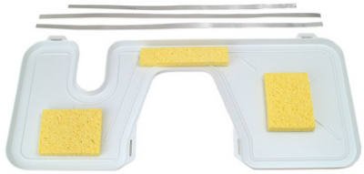 White toilet tank drip tray with yellow sponges in varying shapes.