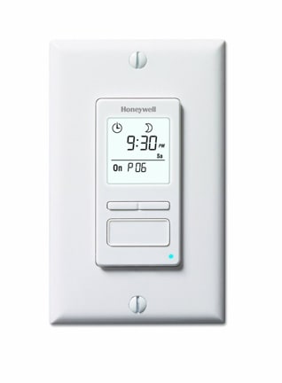 An electronic programmable timer light switch, over a white background.