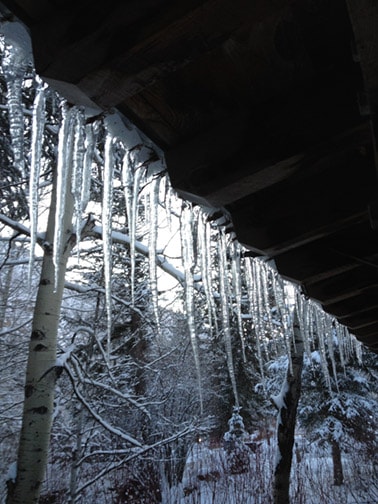 Winter icicles hanging on a roof.