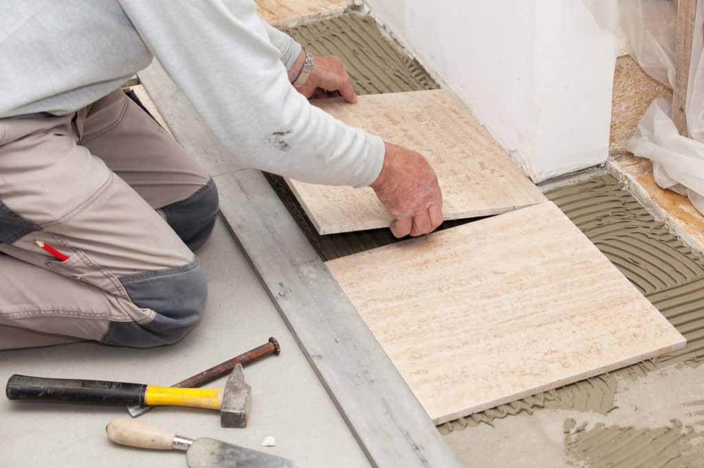 placing second ceramic tile in mortar base with guide