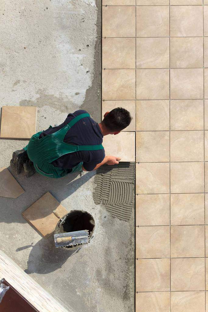 Laying A Ceramic Tile Floor Hometips, How To Lay Ceramic Tile On Cement Floor