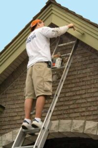 painting exterior house trim with brush