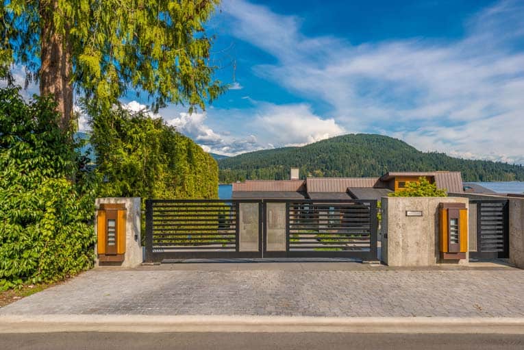 Steel driveway gate glides laterally on tracks.