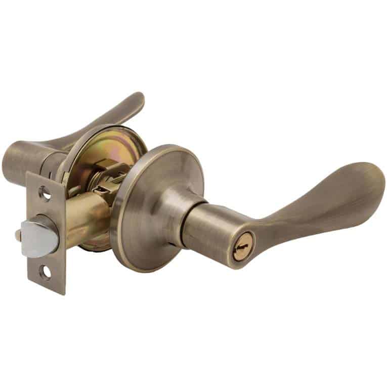 An antique brass finish, lever-style lockset over a white background.