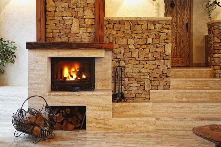 Stylish wood-burning stone fireplace provides a central focal point in this contemporary living room.