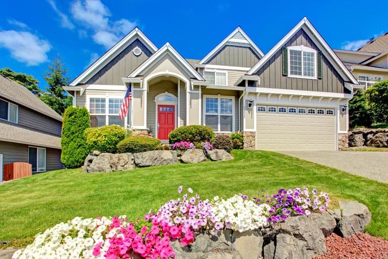 great curb appeal house with lawn flowers door