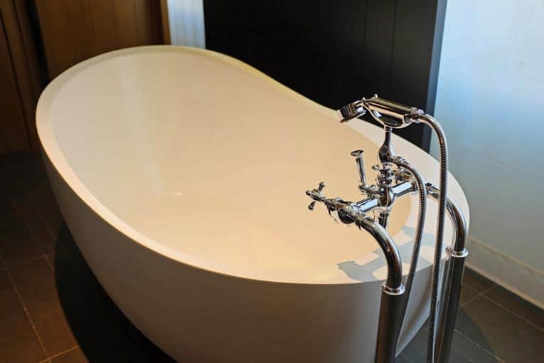 Freestanding bathtub is a sculptural centerpiece in this contemporary bathroom.