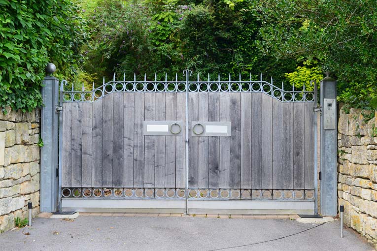 Wood-and-steel swinging driveway gates