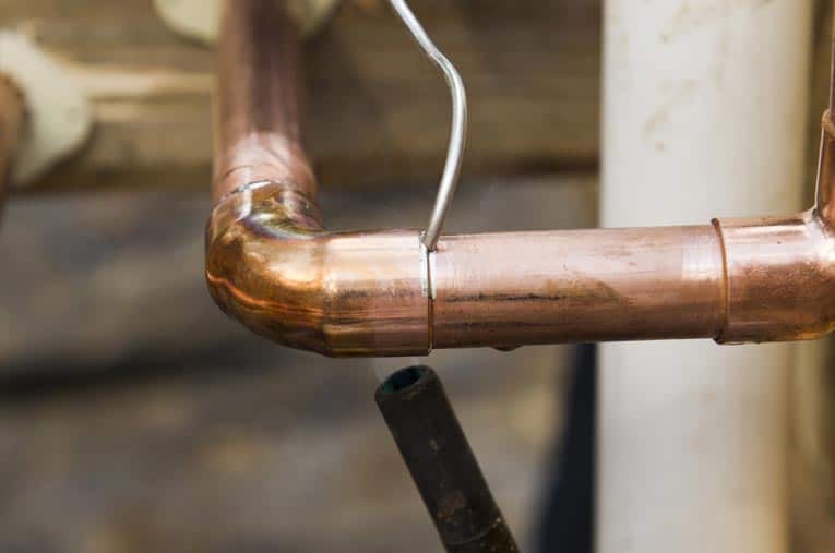 Touch the solder to the joint and watch the capillary action pull it evenly all the way around the connection.