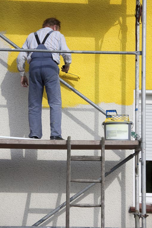 Scaffolding makes the job of painting a two-story home much easier than painting with ladders. 