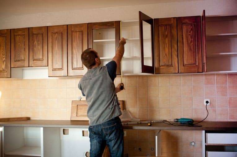 When installing kitchen cabinets, start with the upper cabinets, and then install the base cabinets.