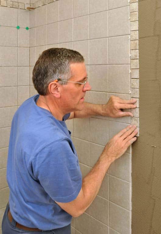 A band of smaller border trim tiles add visual interest to this shower wall.