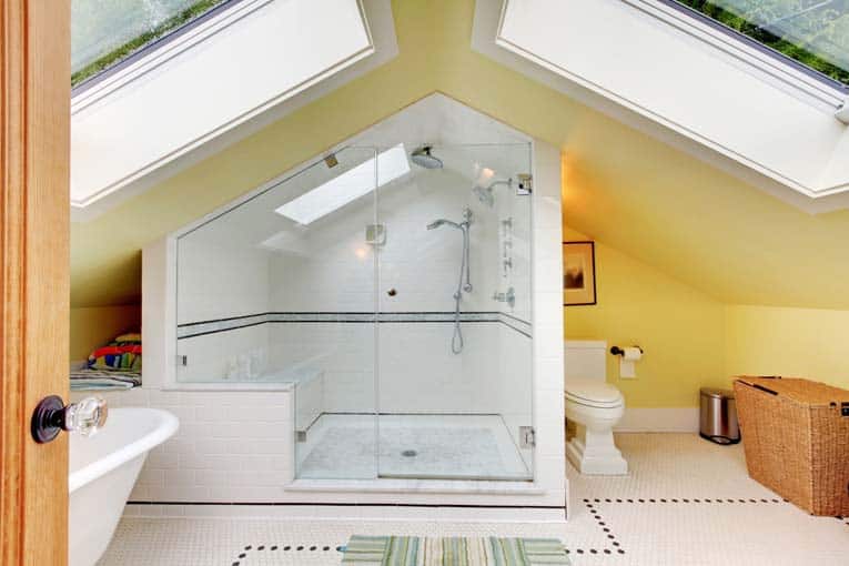 An attic tub and shower bathroom, brightened by two large skylights.