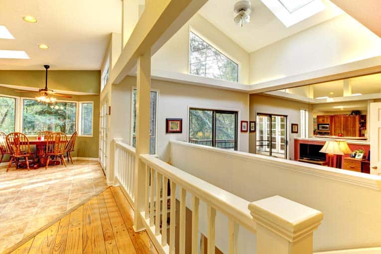 A house's open-plan interior living space, brightened by skylights.