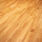 A finished light oak, solid wood floor.
