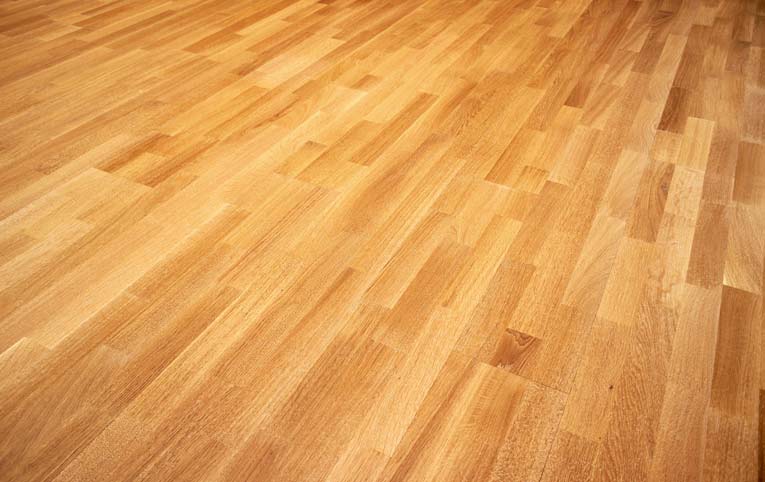 A finished light oak, solid wood floor.