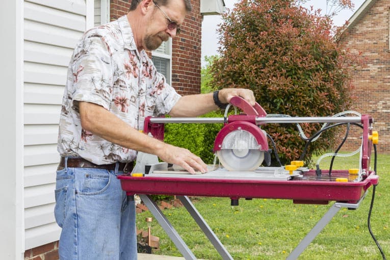 Radial-arm wet saw is easy to use for making straight cuts across ceramic tile.