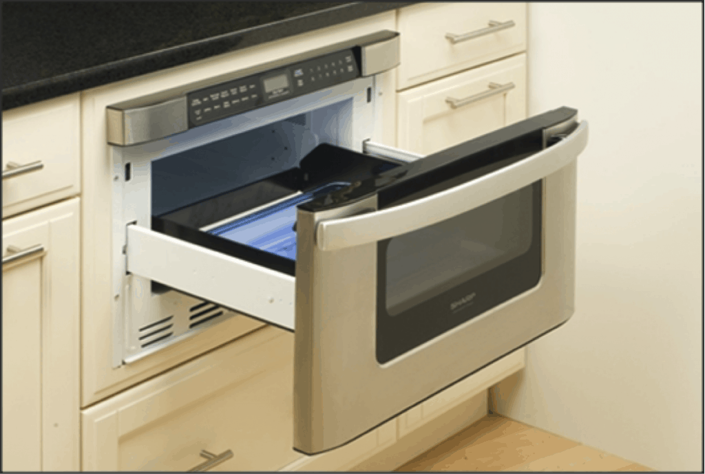 An opened microwave oven drawer below a kitchen countertop.