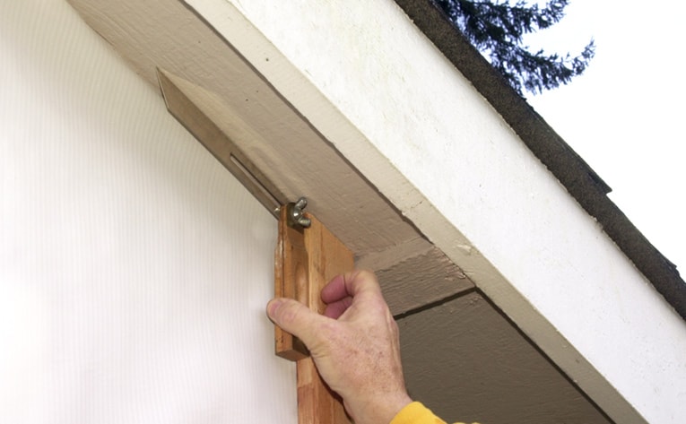Use a sliding T-bevel to transfer the angle of the roof to the siding boards for making the necessary cuts.
