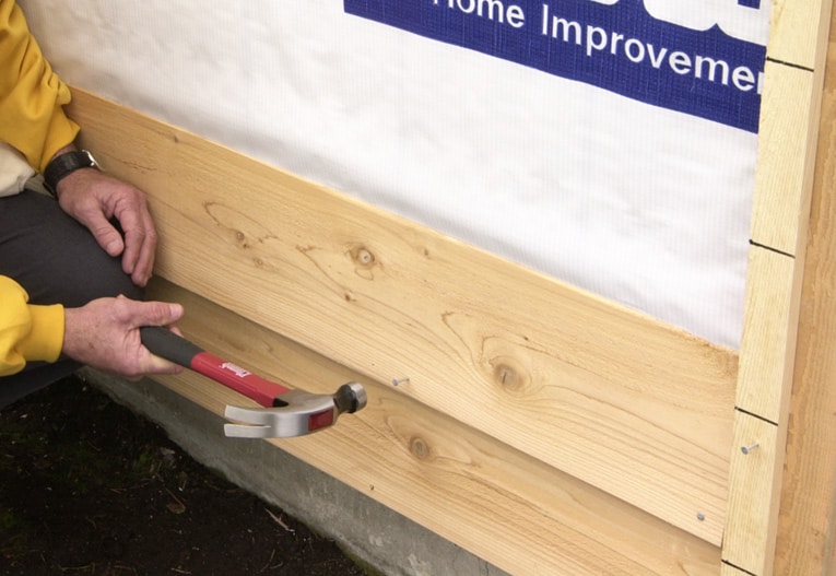 Position and nail the next siding board, placing and spacing nails as recommended by the manufacturer.
