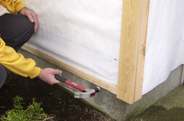Install a starter strip along the bottom edge of the wall. Be sure it's level.