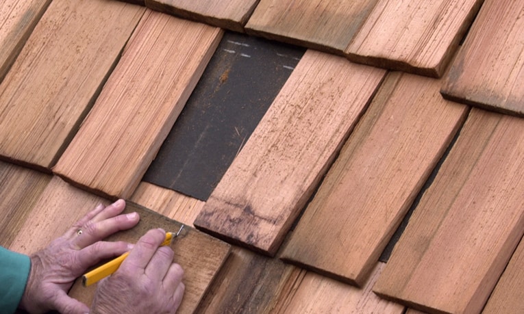 Measure for the width of the replacement shingle, allowing about 1/2 inch of spacing on both sides.