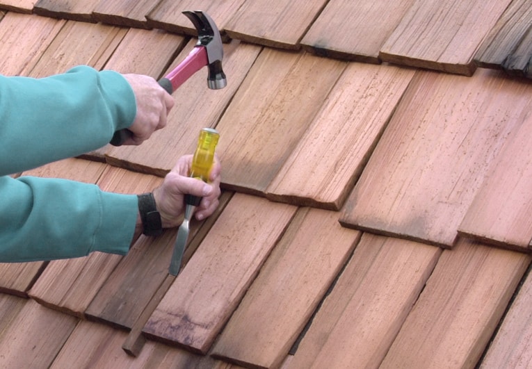 To remove a damaged wood shingle, split it with a wood chisel and pull out the pieces.