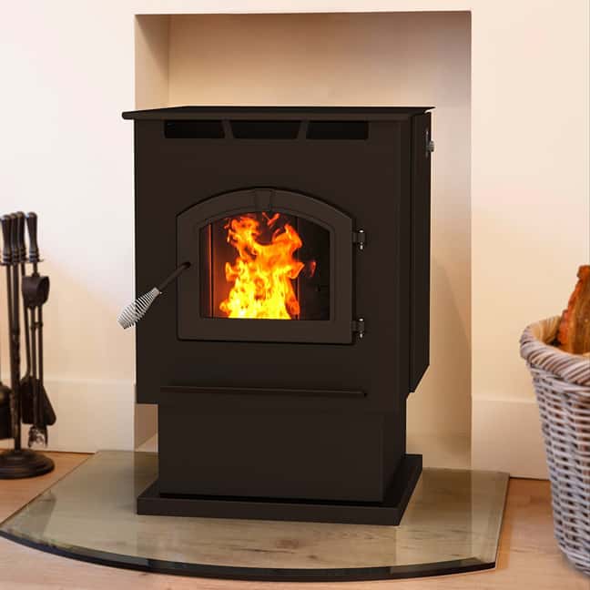 A burning brown pellet stove in a living area.