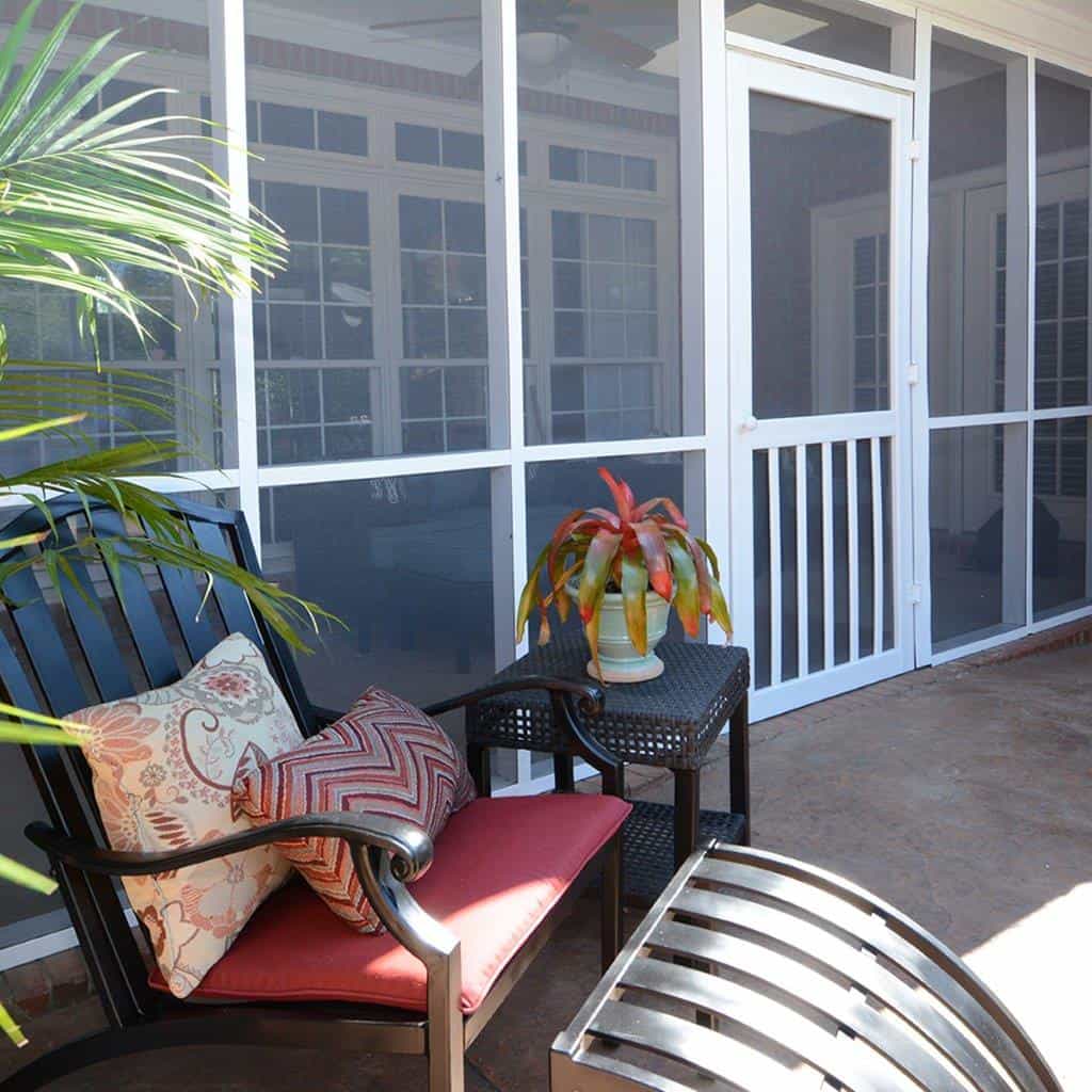 A house's porch with fiberglass screened panels.