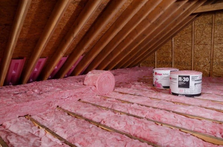 Unfaced insulation rolls insulating attic