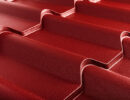 Closeup of textured red metal roofing.