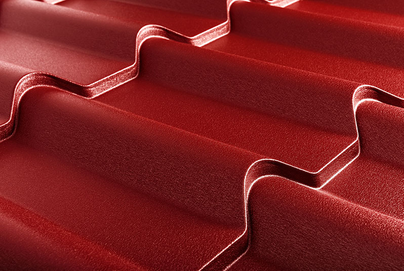 Closeup of textured red metal roofing.