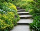 Smooth-cut flagstone stairs leading through a lush garden.