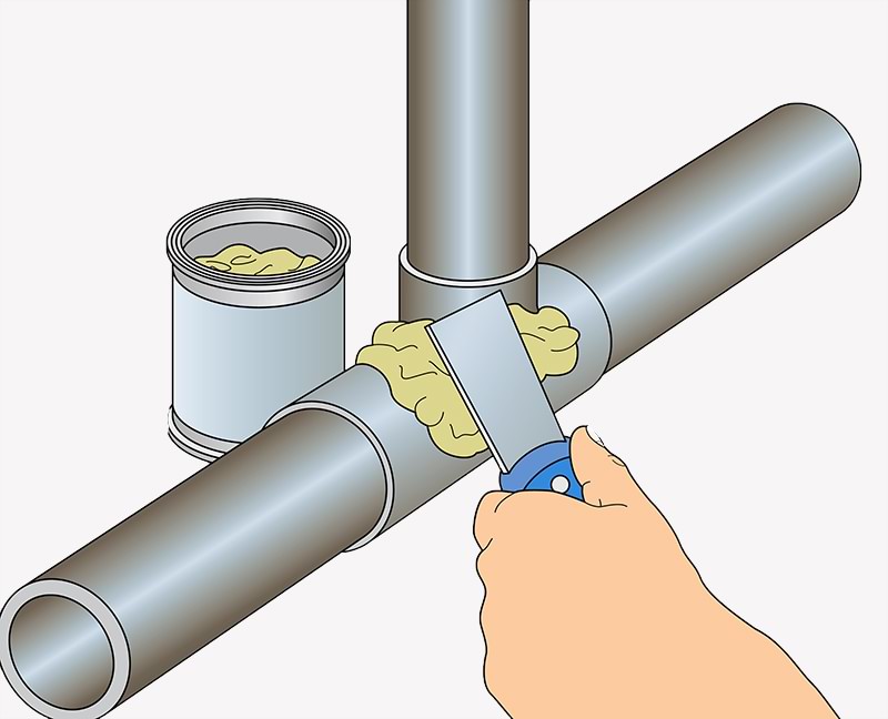 Hand applying epoxy putty to a leaky pipe joint.