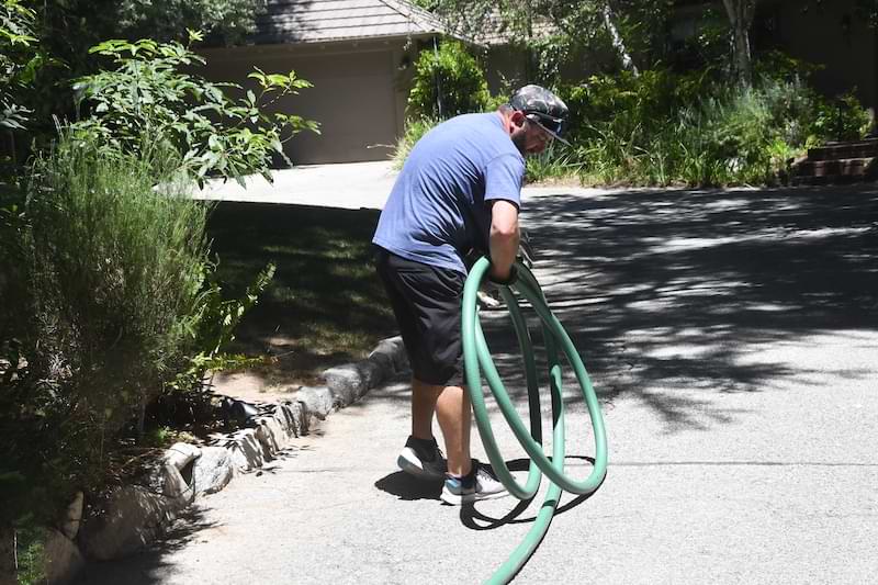 unrolling large hoses on driveway
