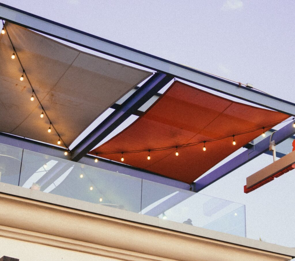 Colorful fabric roof panels shelter a rooftop pato