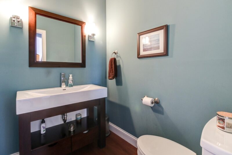 small basement bathroom with narrow vanity and sink